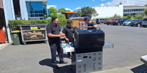 People standing around a BBQ